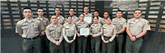 Cadets With Certificates by Memorial Wall
